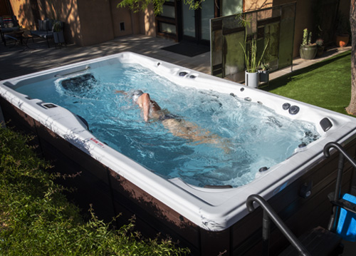Triathlete Ben hoffman swimming in a swim spa